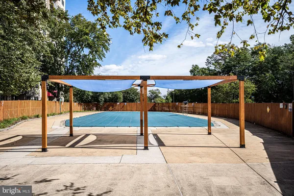 a view of a patio with a table and chairs under an umbrella