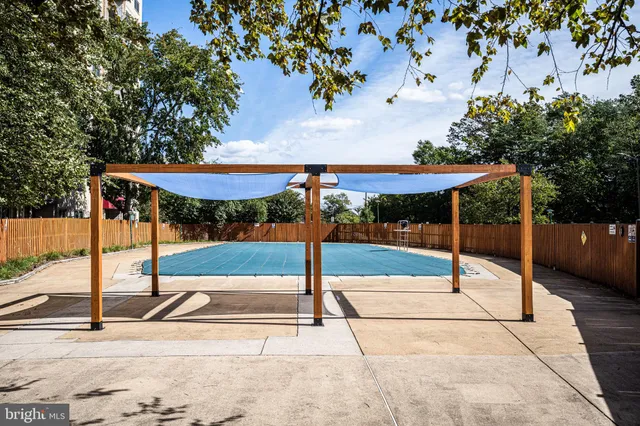 a view of a patio with a table and chairs under an umbrella