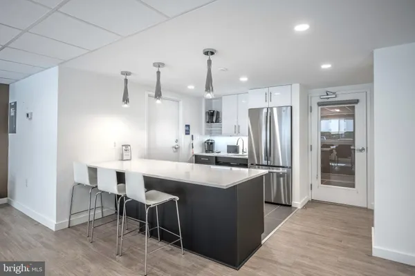a kitchen with kitchen island a sink stove and refrigerator