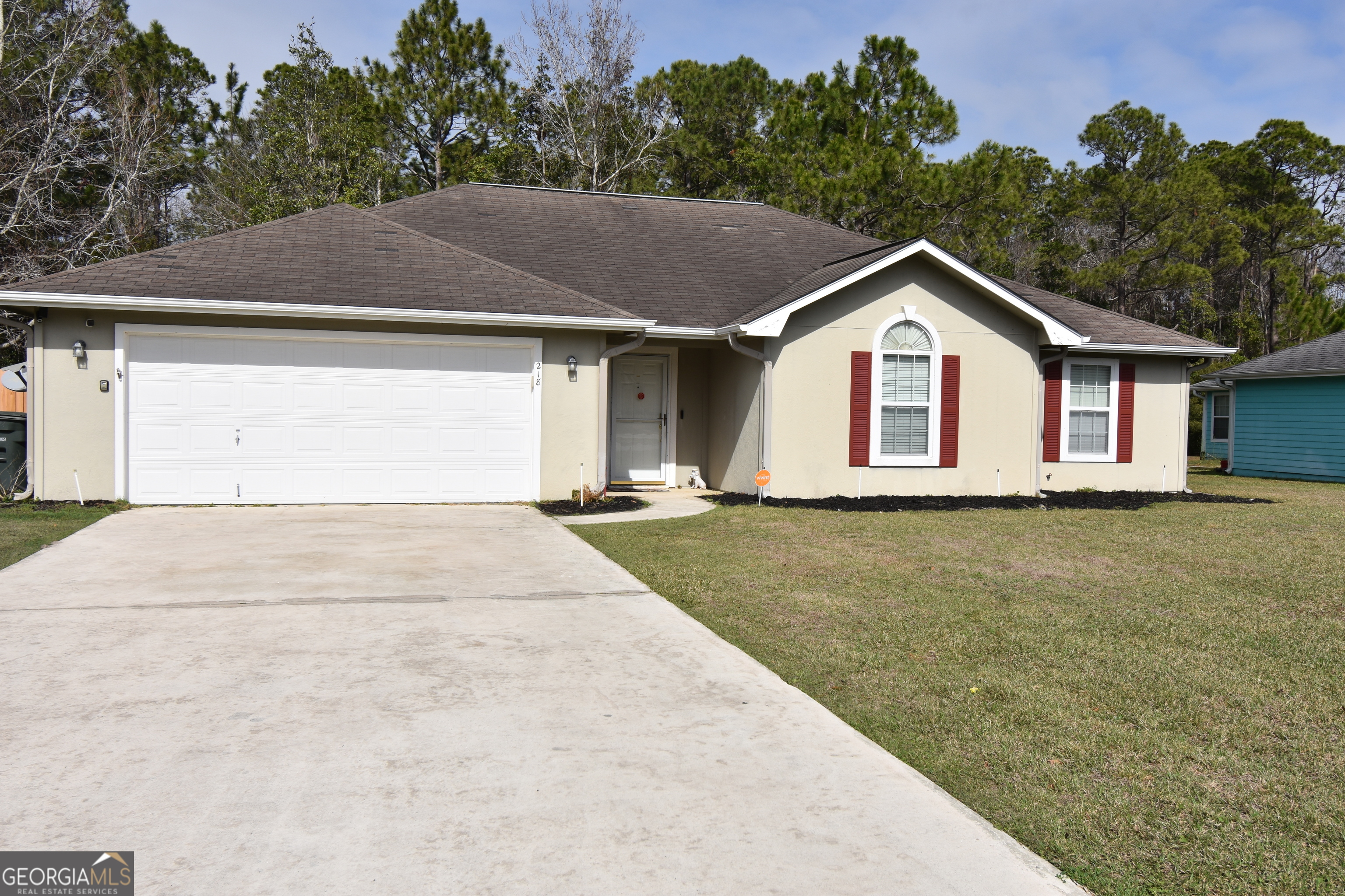 218 Lake Forest Drive Kingsland, GA 31548 - Photo 1 of 17 a view of a white house with a yard plants and large tree