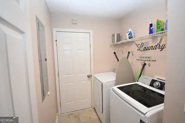 a view of storage and utility room with washer and dryer