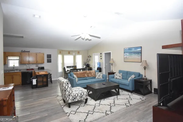 a living room with fireplace furniture and a wooden floor