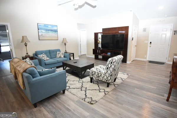 a living room with furniture and a flat screen tv