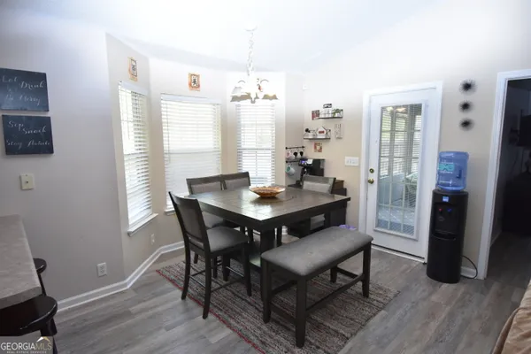 a view of a dining room with furniture window and wooden floor