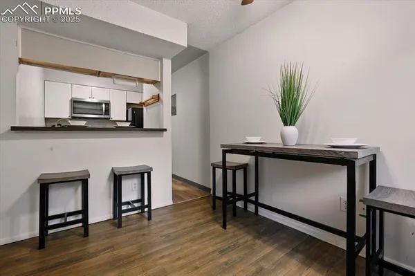 a view of a balcony with furniture and wooden floor