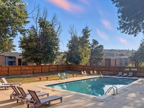 a view of swimming pool with chairs