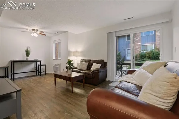 a living room with furniture and a wooden floor