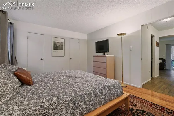 a bathroom with a granite countertop toilet sink and mirror