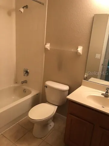 a bathroom with a toilet a sink and bathtub