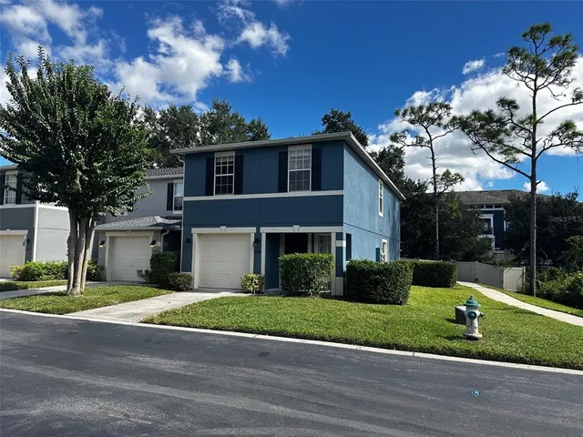 a front view of house with yard and green space