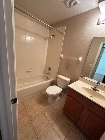 a bathroom with a granite countertop sink toilet a mirror and shower