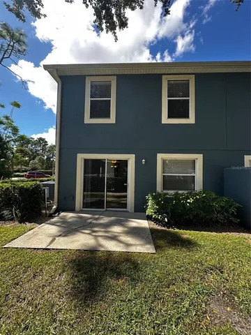 a view of a house with backyard and garden
