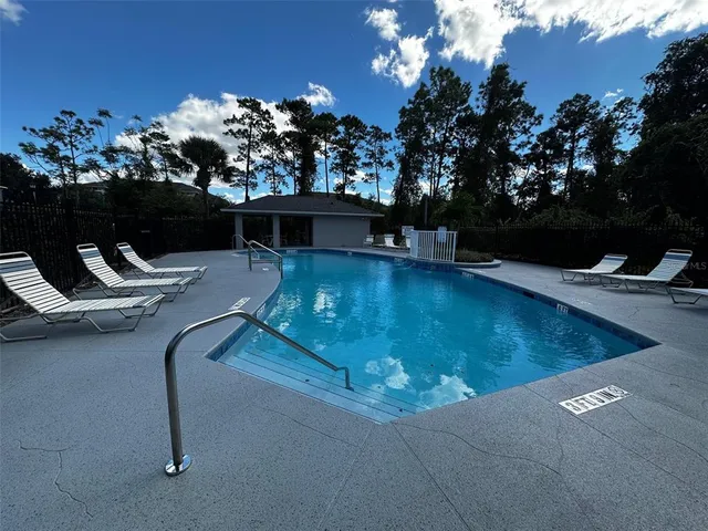 a view of a swimming pool with lounge chair