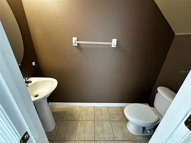 a white toilet sitting next to a small bathroom