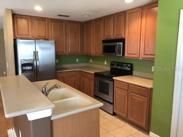 a kitchen with a sink a stove and refrigerator