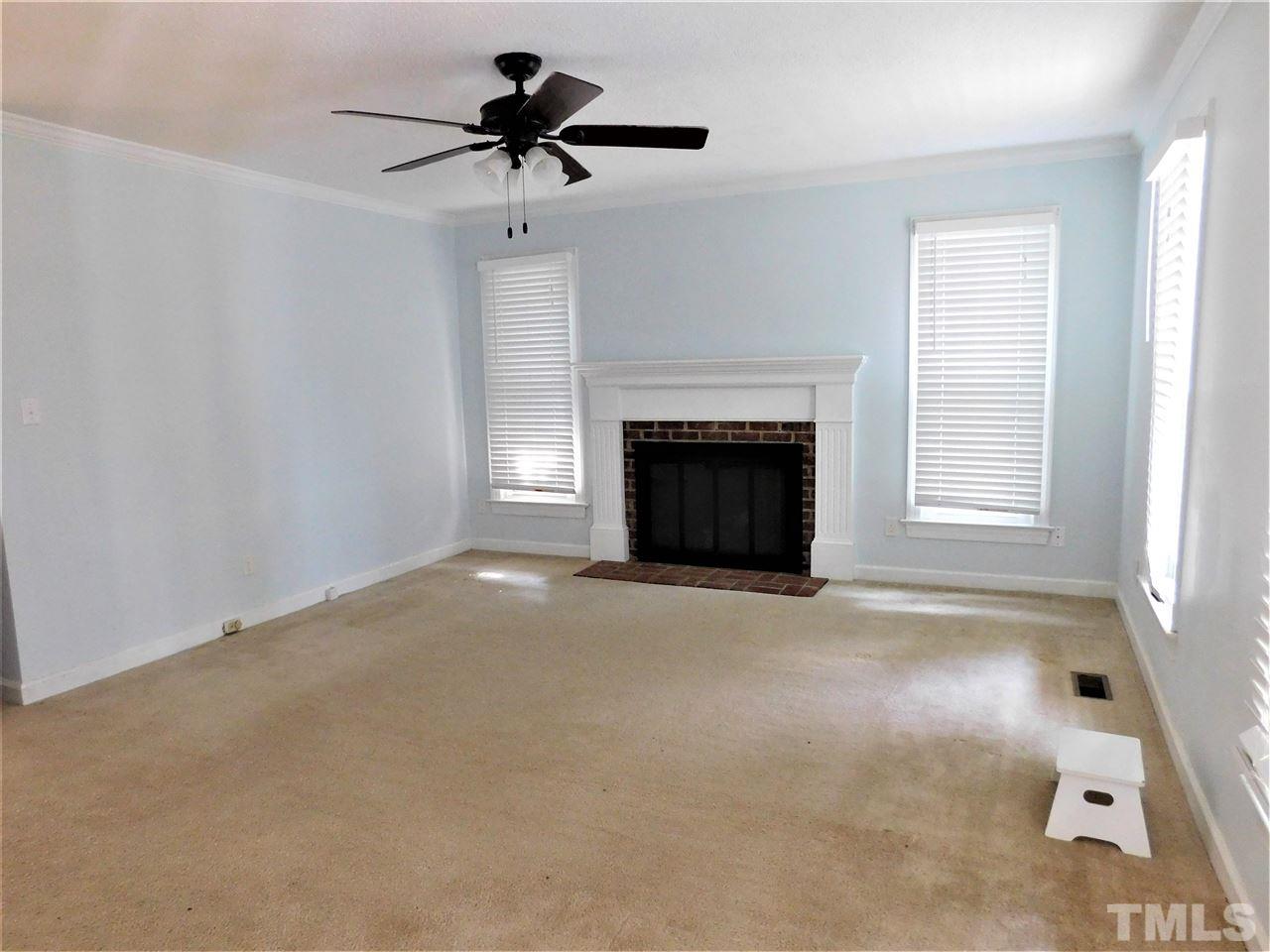 3917 Iron Horse Road Raleigh, NC 27616 - Photo 14 of 19 a view of a livingroom with a fireplace and a chandelier fan
