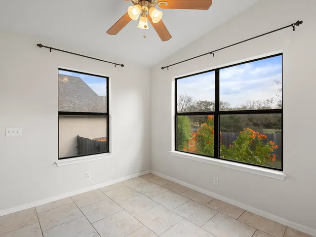 an empty room with windows and closet