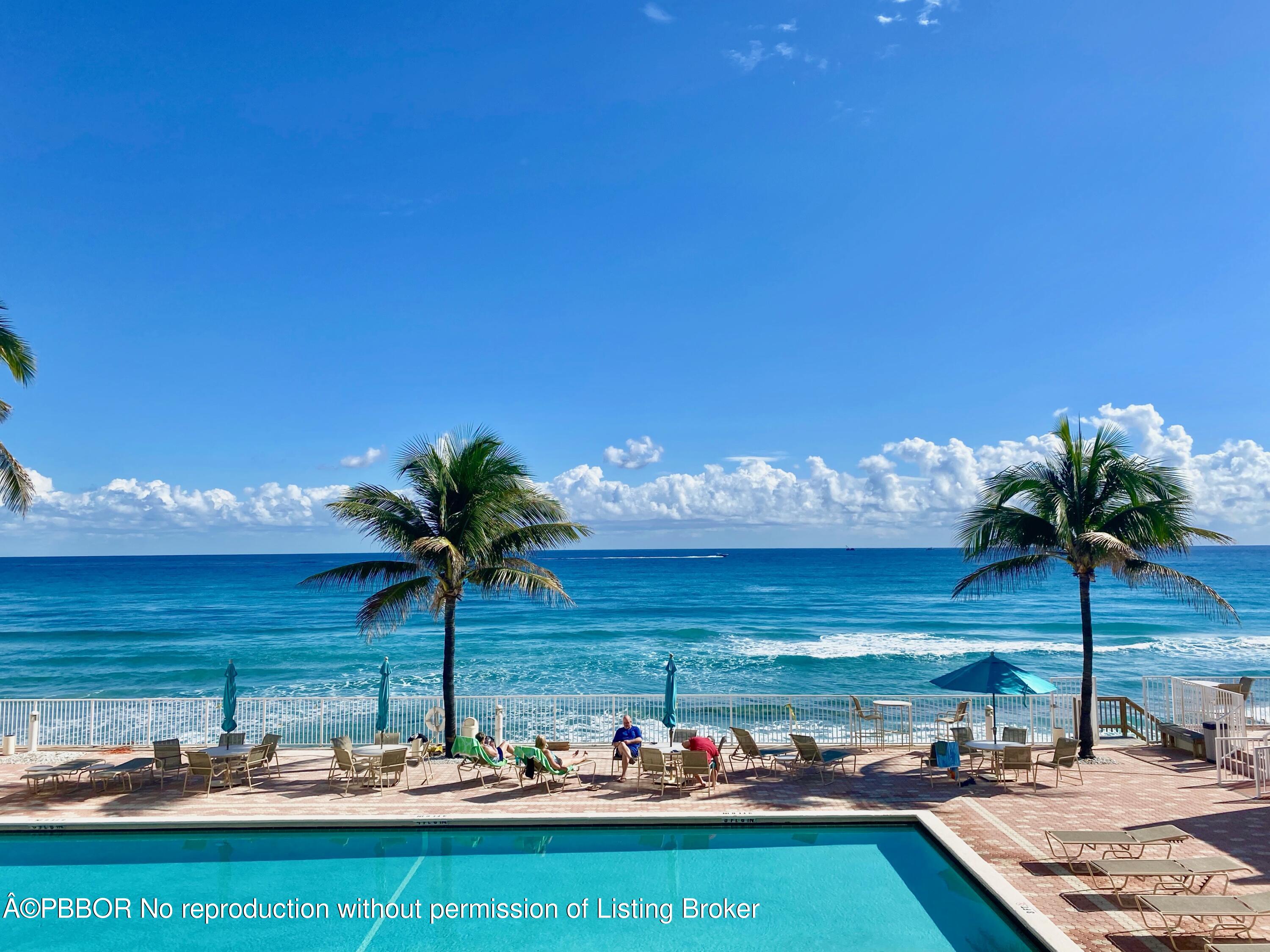 a view of a pool with a table and chairs