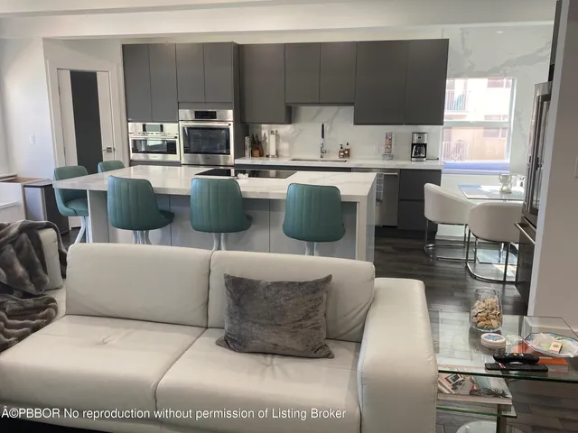 a kitchen with stainless steel appliances kitchen island granite countertop a sink and a stove top oven