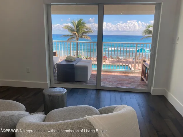 a living room with furniture and a floor to ceiling window