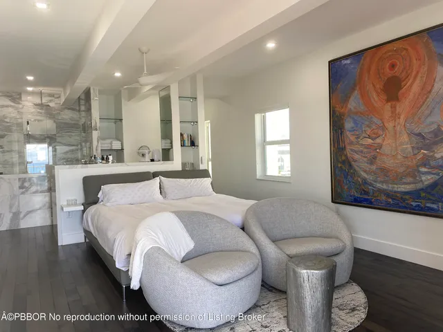 a spacious bedroom with a bed and a couch