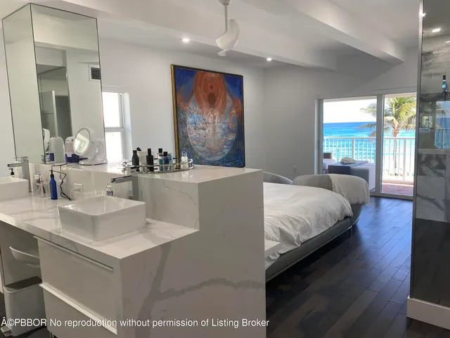 a bedroom with a large bed and a large mirror