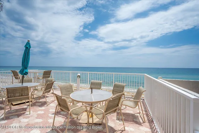 a balcony with a table and chairs