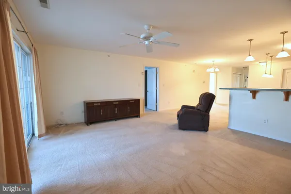 a view of an empty room with a cabinet and a flat screen tv