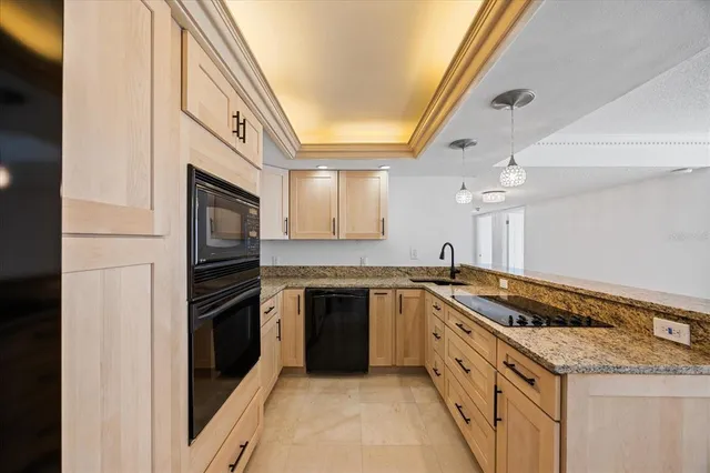 a kitchen with granite countertop cabinets stainless steel appliances and a counter space