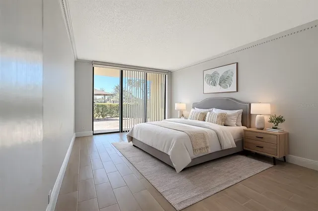 a spacious bedroom with a bed and a large window