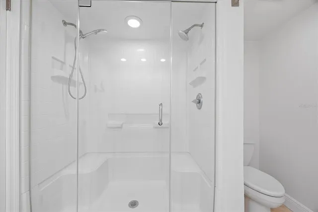 a bathroom with a shower and a toilet