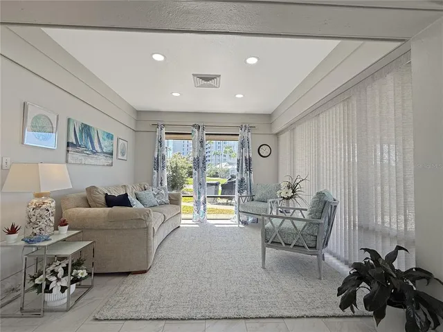 a living room with furniture and large windows