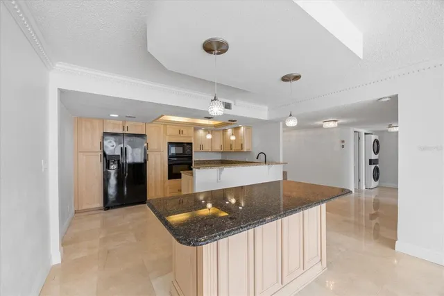a kitchen with stainless steel appliances a refrigerator and a counter space