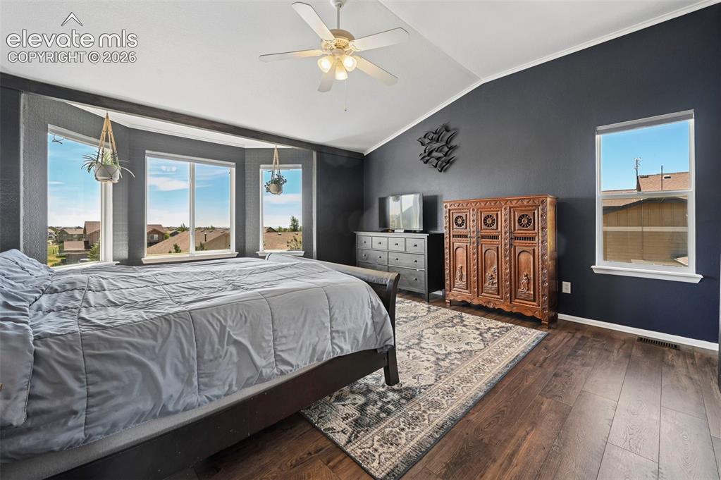 10643 Pictured Rocks Drive Peyton, CO 80831 - Photo 14 of 37 a bedroom with a large bed and a large window
