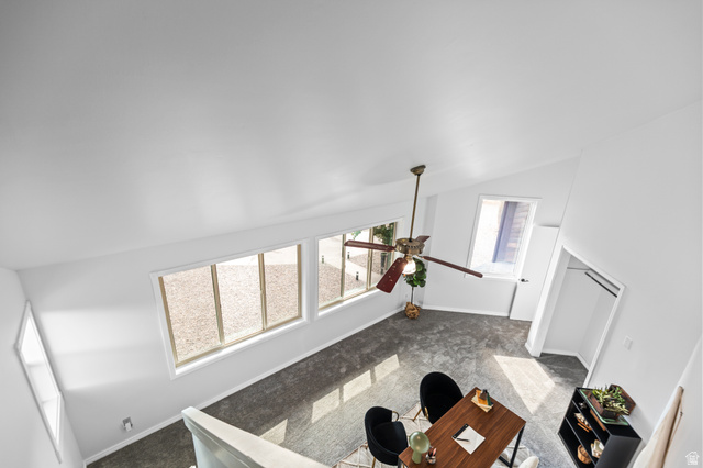 460 Omni Point Road Central Valley, UT 84754 - Photo 52 of 101 Vaulted white ceiling with a ceiling fan, multiple windows with white trim, and a built-in closet with hanging rods