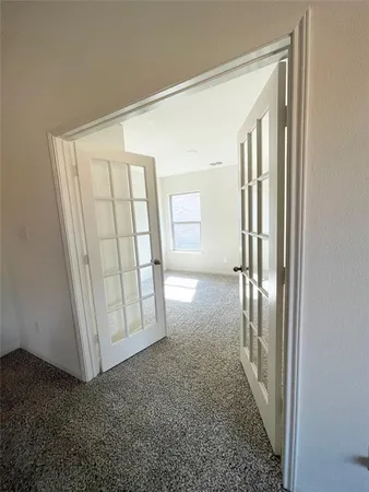 an entryway with a door and wooden floor
