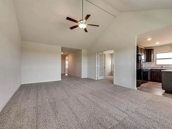 a view of a livingroom with a ceiling fan and window