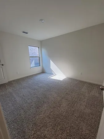 a view of a big room with closet and windows