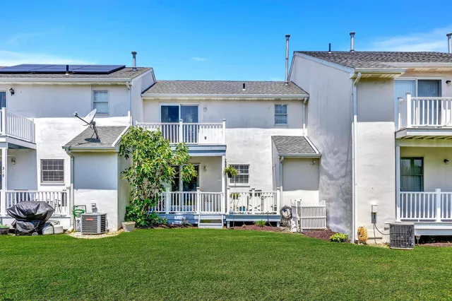a front view of a house with a garden and plants