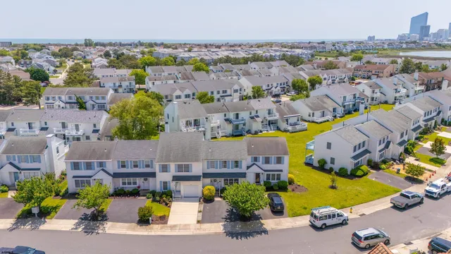 an aerial view of lake residential houses with outdoor space and ocean view