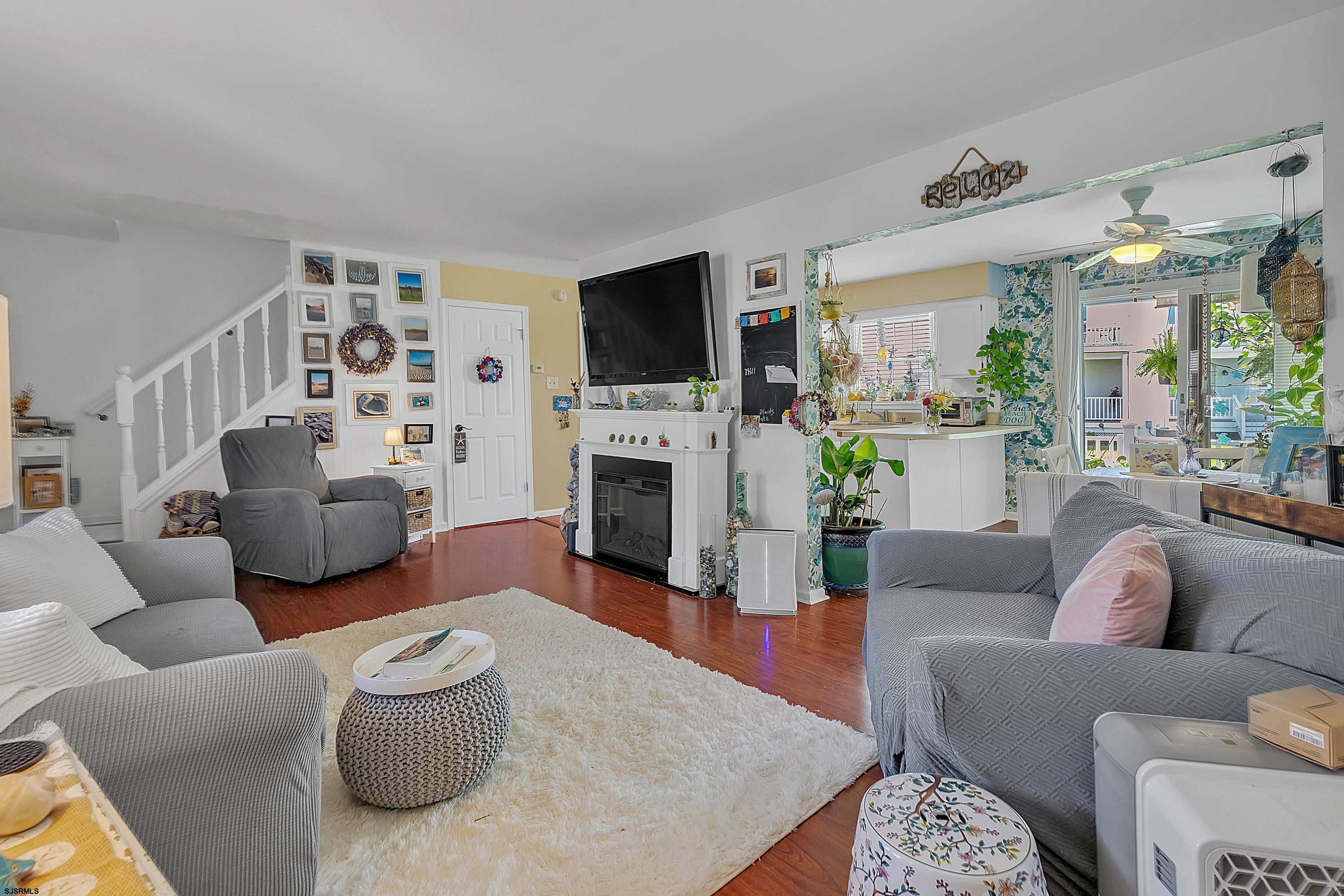 316 Gull Cove Brigantine, NJ 08203 - Photo 5 of 32 a living room with furniture a flat screen tv and a fireplace