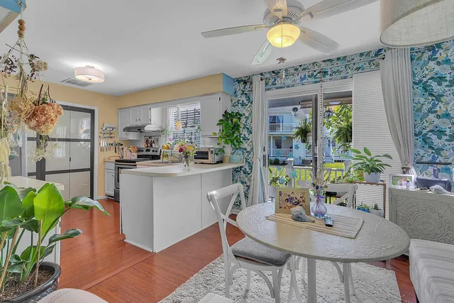 a kitchen with a table chairs and entryway