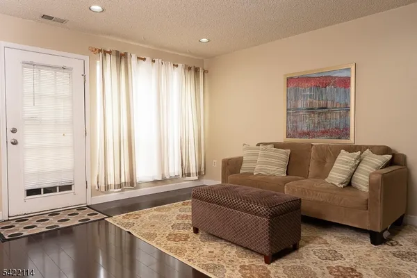 a view of a living room with furniture and a window