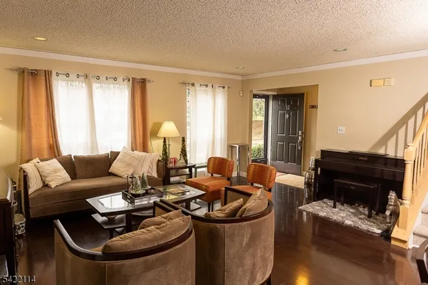 a living room with furniture and a stair