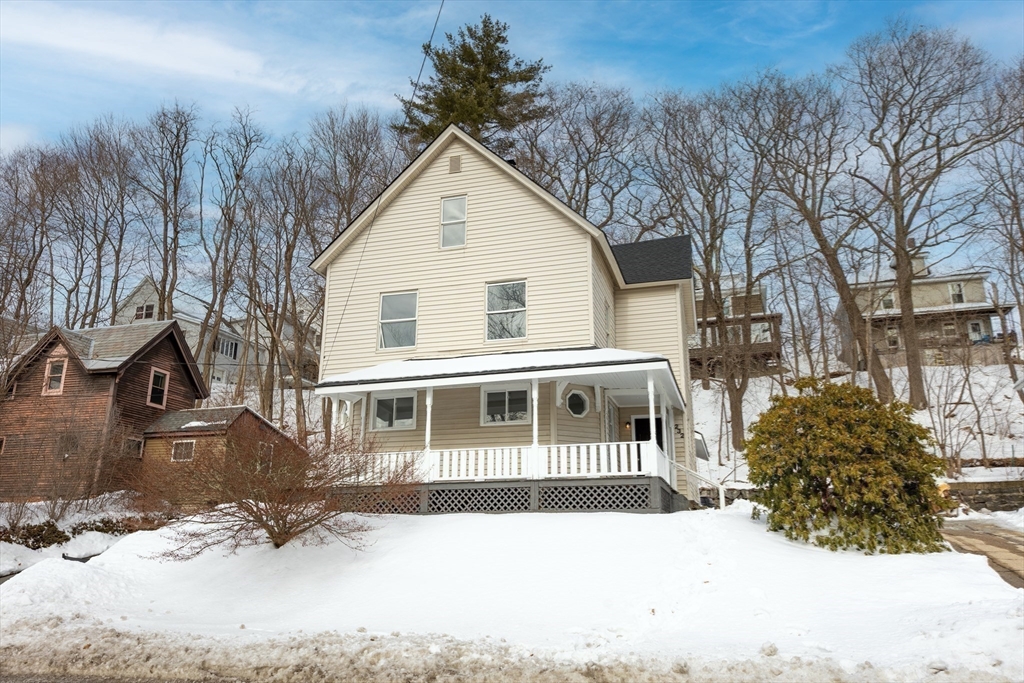 232 Pequoig Avenue, Unit 2 Athol, MA 01331 - Photo 1 of 17 a front view of a house with a yard covered in snow