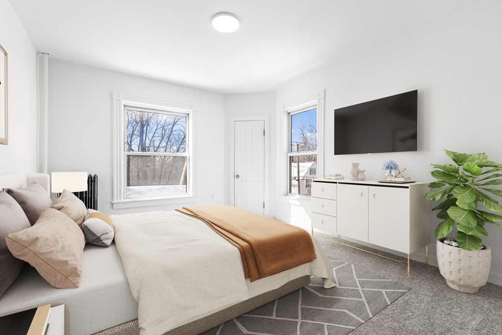 232 Pequoig Avenue, Unit 2 Athol, MA 01331 - Photo 12 of 17 a bedroom with a bed and a flat screen tv