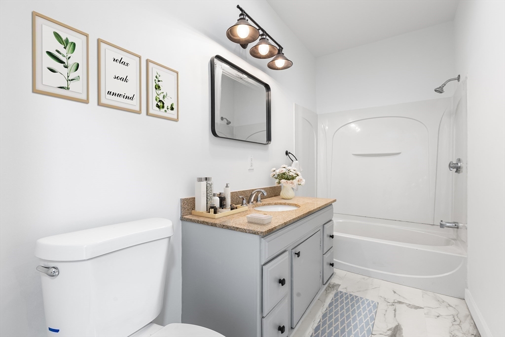 232 Pequoig Avenue, Unit 2 Athol, MA 01331 - Photo 13 of 17 a bathroom with a toilet sink and mirror