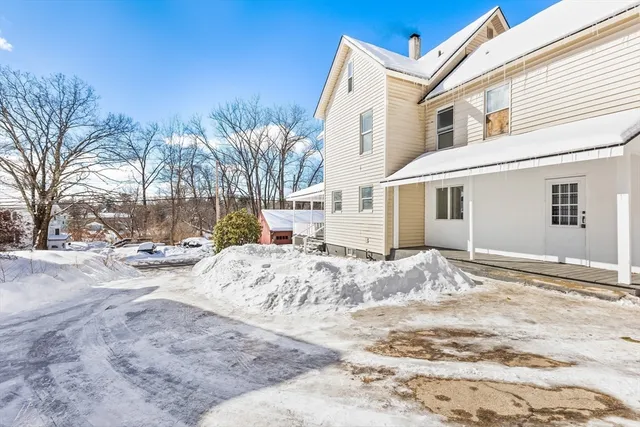 a view of a house with snow on the road