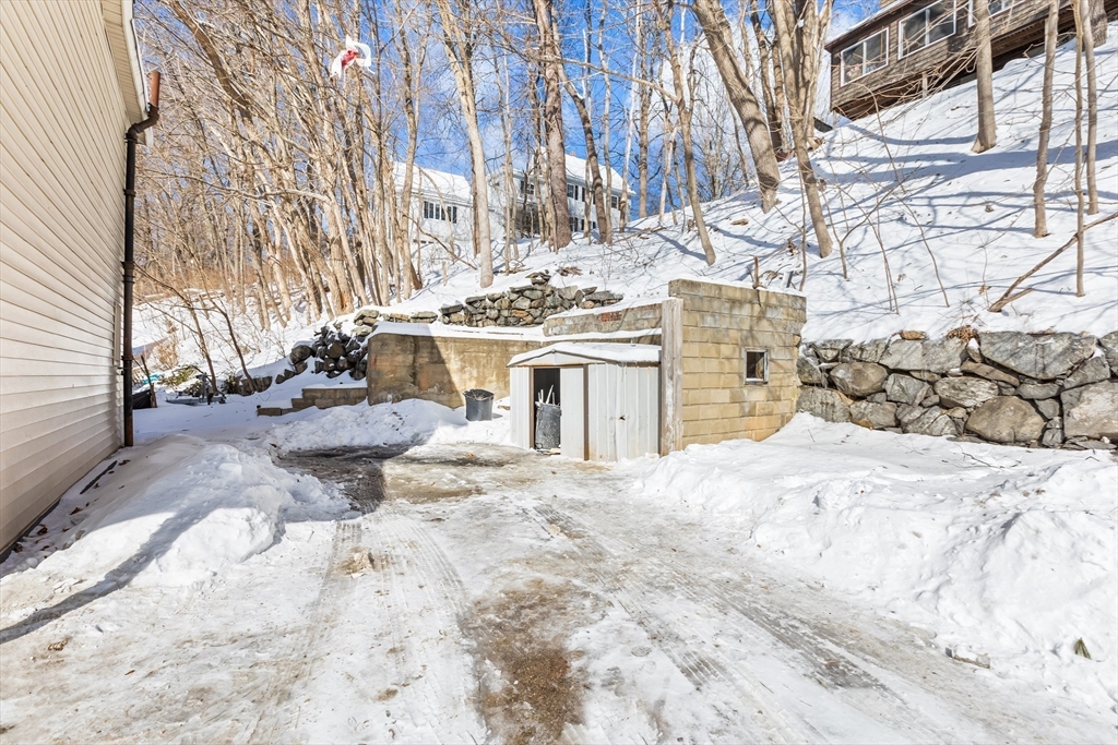 232 Pequoig Avenue, Unit 2 Athol, MA 01331 - Photo 16 of 17 a view of a white house with a yard covered in snow
