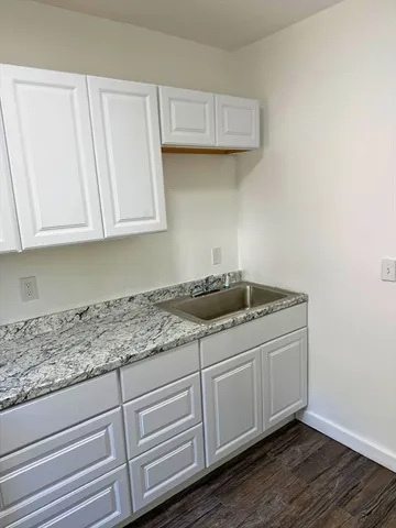 a kitchen with granite countertop cabinets and sink